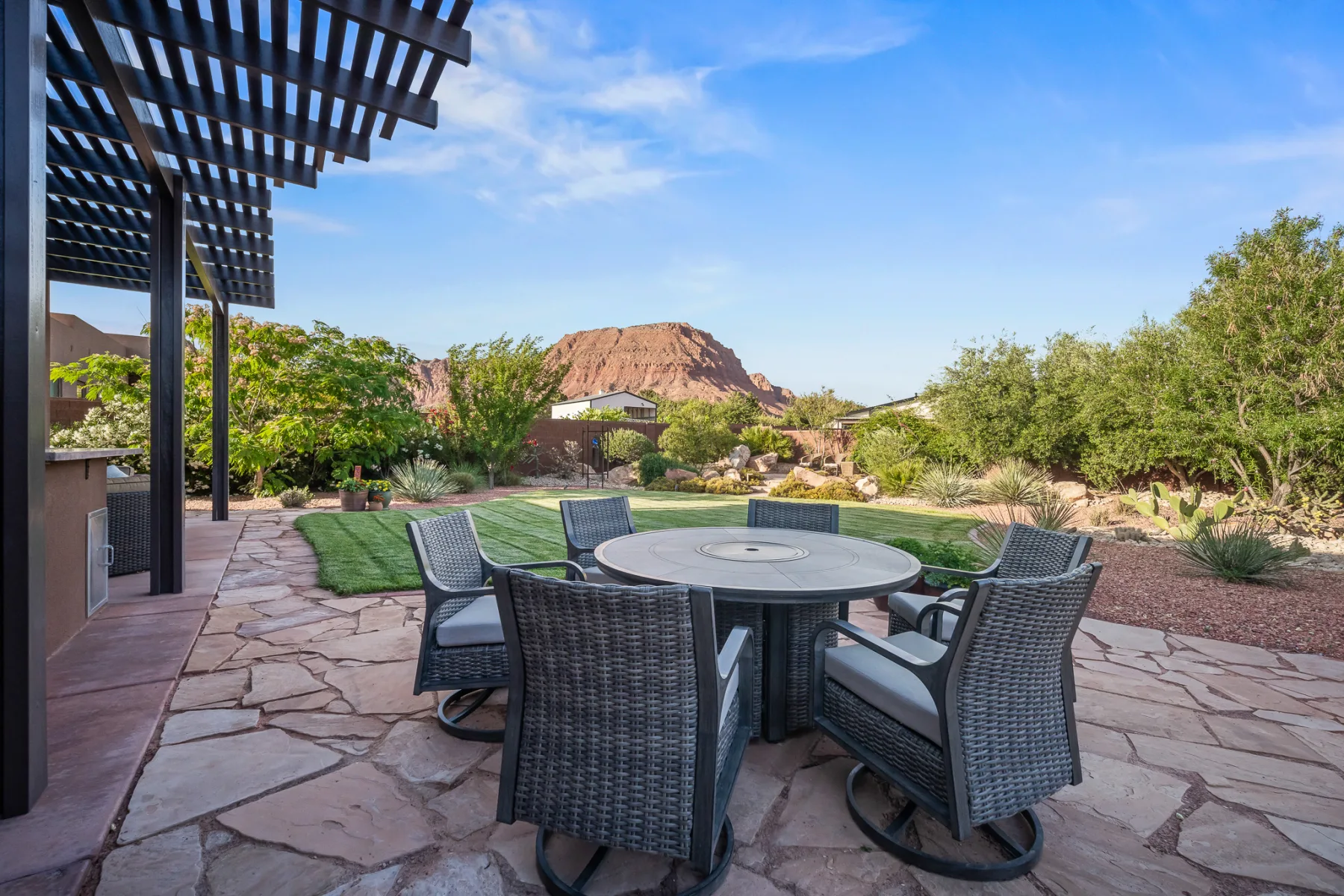 Landscaped Ivins backyard with red-rock views